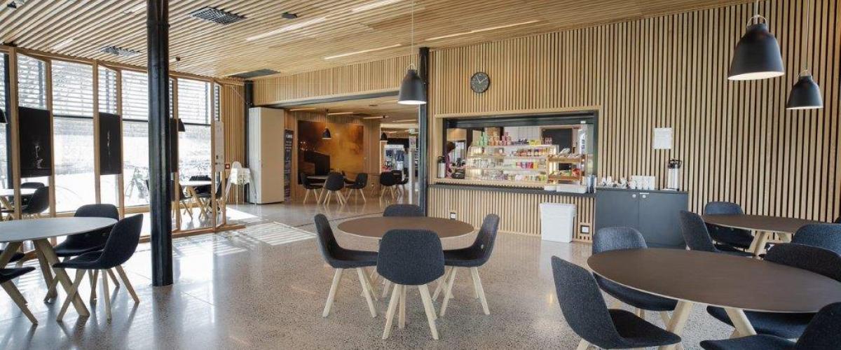 Kafé med bord og stoler i luftig område